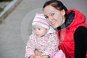 Happy mom and child girl hugging on nature The concept of childhood and family