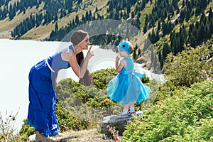 Happy mom and child girl hugging on nature The concept of childhood and famiy