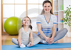 Happy mom and child spends time in the gym