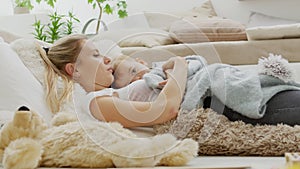 Happy mom cuddles her son child baby, lying at home between pillows, healthy and cared for growth concept photo