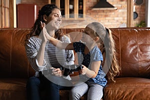 Happy mom and daughter celebrate win in video game