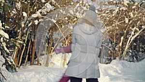 Happy mom and daughter hug and play in the suburbs in winter.