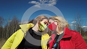 Happy mom and doughter in masks outdoors photo