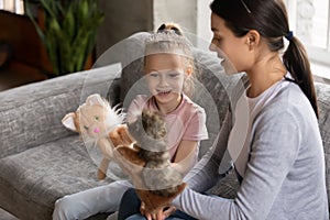 Happy mom and excited daughter girl wearing princess tiara photo