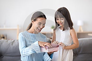 Happy mom open birthday package with cute daughter