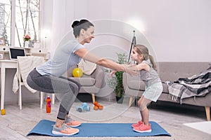 Happy mom training with her little daughter