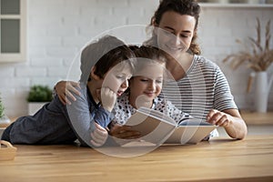 Happy mom and two sibling kids involved in fairy tale