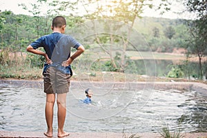 Happy moment Asian boy playing water in outdoor