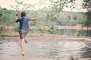 Happy moment Asian boy playing water in outdoor