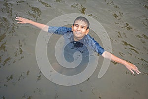 Happy moment Asian boy playing water in outdoor