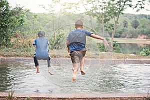 Happy moment Asian children playing water in outdoor