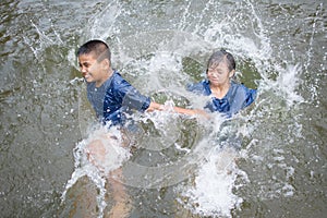 Happy moment Asian children playing water in outdoor