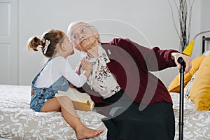 Happy moments. Little girl with her great grandma spending quality time together
