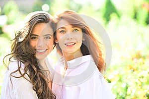 Happy moments of two girls in park. Closeup portrait funny joyful young women having fun, smiling, lovely moments, best