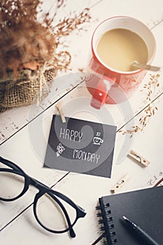 Happy Monday massage on notebook with coffee