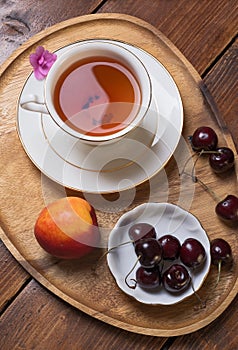 Happy  morning . life style shot morning tea with  cherry and peach at wooden tray