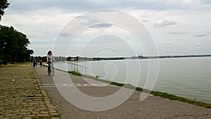 Happy mother and adult daughter riding bicycles