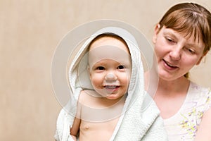 Happy mother with baby after bath