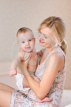 Happy mother with baby boy indoors