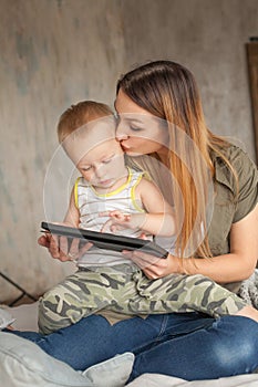 Happy Mother with Baby Boy and Tablet pc computer learning