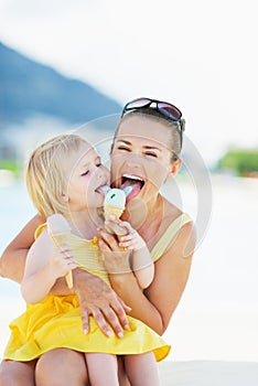 Happy mother and baby eating ice cream