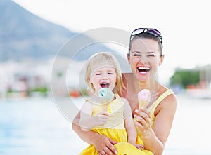 Happy mother and baby eating ice cream