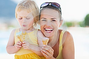 Happy mother and baby eating ice cream