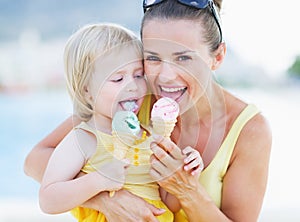 Happy mother and baby eating ice cream