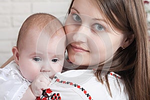 Happy mother and baby. Family, child and parenthood concept - happy smiling young mother with little baby