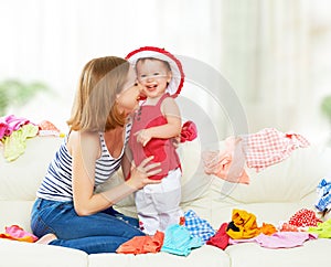 Happy Mother and baby girl with clothes ready for traveling on