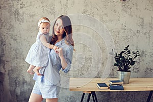 Happy mother and baby playing at home in bedroom