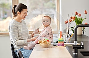 Happy mother with baby working at home office