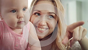 Happy mother with baby. Smiling woman embrace her kid