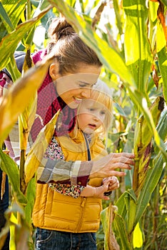 Happy mother and child exploring cornfield