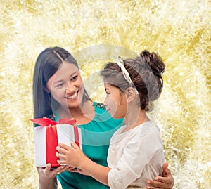 Happy mother and child girl with gift box