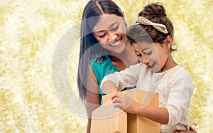 Happy mother and child girl with gift box