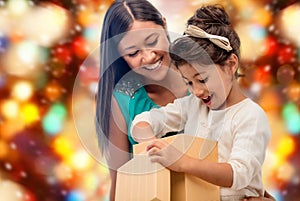 Happy mother and child girl with gift box