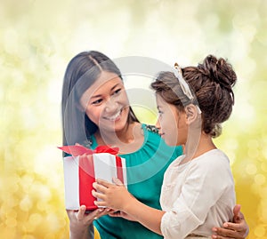 Happy mother and child girl with gift box