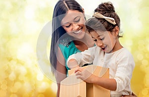 Happy mother and child girl with gift box