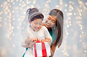 Happy mother and child girl with gift box