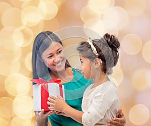 Happy mother and child girl with gift box