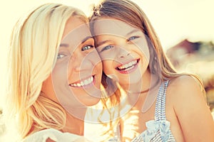 Happy mother and child girl outdoors