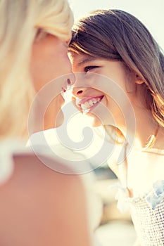 Happy mother and child girl outdoors