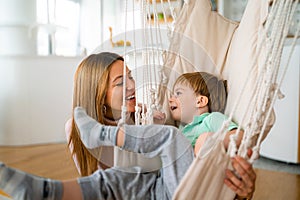 Happy mother with child playing and hugging at home. Happiness, parenting, childhood concept.