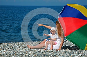 Happy mother with child under umbrella