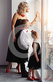 happy mother with children near the window