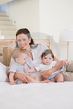 Happy mother with cute babies boy and girl