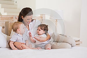 Happy mother with cute babies boy and girl