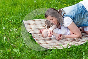 Happy mother and cute baby girl playing outdoor