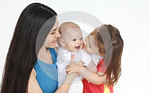 Happy mother and cute little kids spending time together and smiling at camera